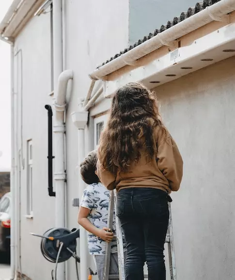 Two people searching outside during a scaveger hunt activity